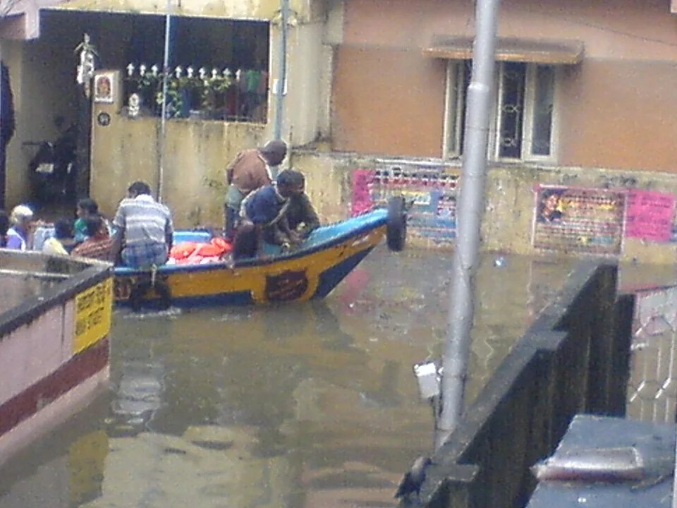 Boat on a flooded residential street in Chennai during heavy rain